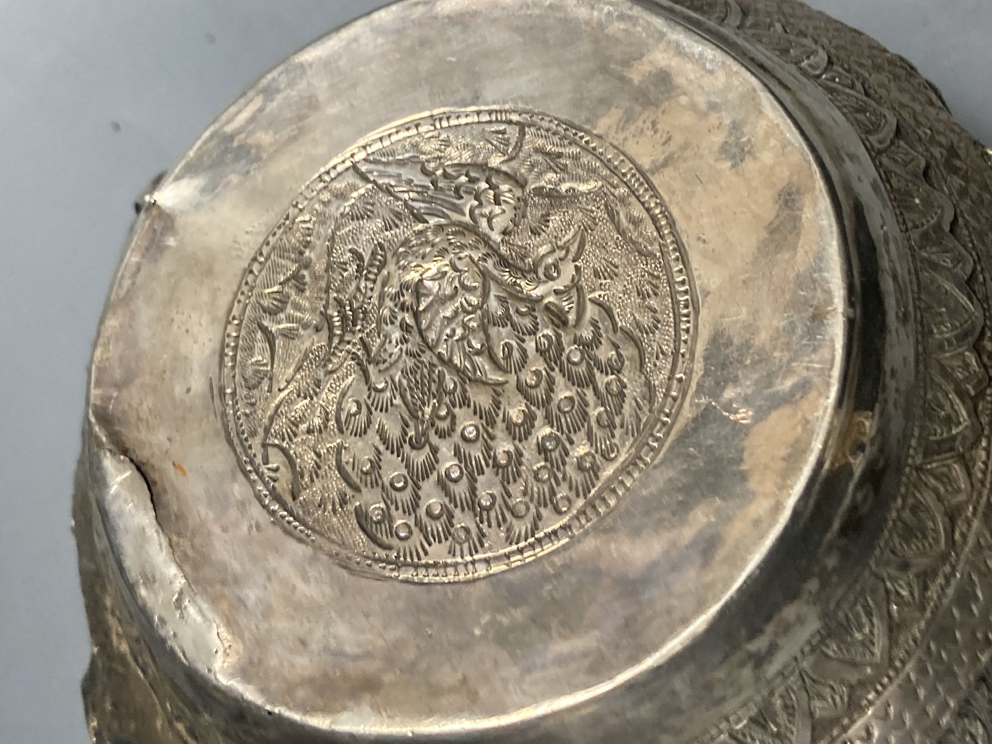 A small Burmese white metal bowl, embossed with deities, repaired, width 15.5c m, gross 10 oz.